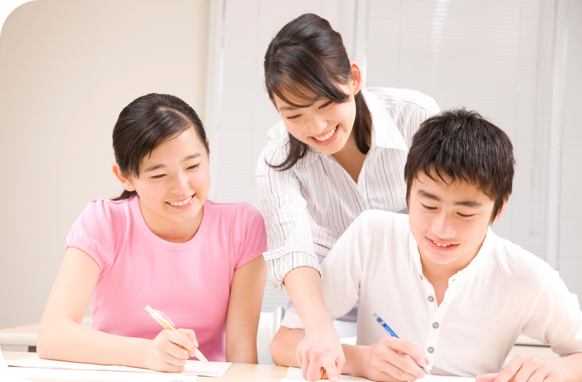 2人の学生に勉強を教える女性教師